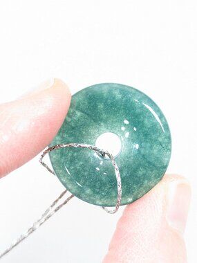 Greenstone donut pendant on long silver toned chain
